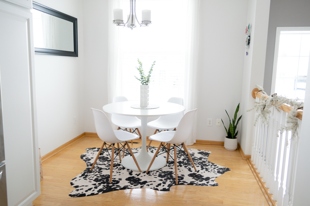 neutral kitchen decor, ikea docksta table, eiffel kitchen chairs, breakfast nook, faux cowhide rug